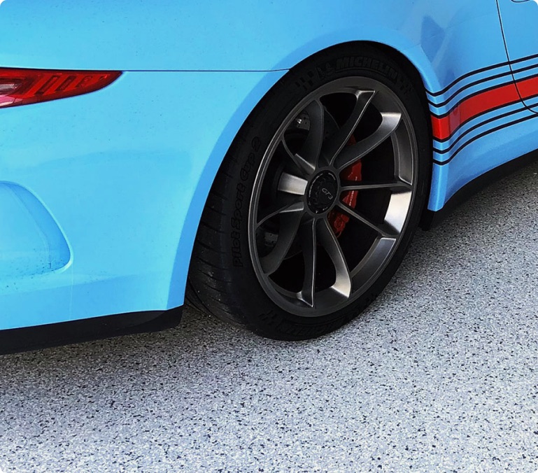 Sports car parked on a glossy epoxy-coated garage floor